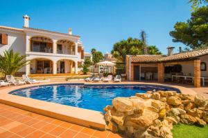 a home with a swimming pool and a house at Villa Oceanic - PlusHolidays in Calpe