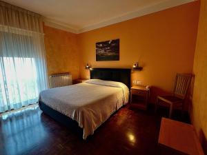 Ένα ή περισσότερα κρεβάτια σε δωμάτιο στο Albergo Di Murlo