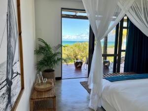 a bedroom with a bed and a view of the ocean at VillaTwo@Tsai-Tsai in Vilanculos