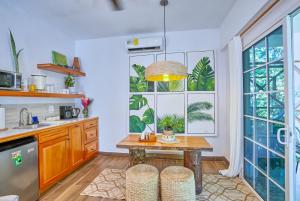 a kitchen with a table and two stools at Villa Massis Luxury Villas in San Ignacio