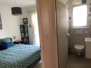 a small bedroom with a bed and a bathroom at Capbreton hossegor chambre climatisée espace privé in Bénesse-Maremne +7 photos