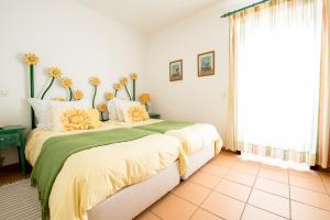a bedroom with a large bed with flowers on it at Betica Hotel Rural in Pias
