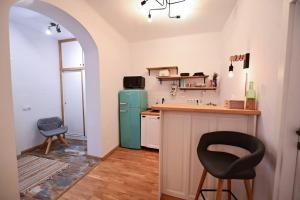 a kitchen with a green refrigerator and a counter at FLH - Zen Apartment in Sibiu