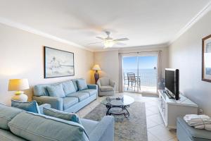 a living room with a couch and a tv at Ocean House II 2602 in Gulf Shores
