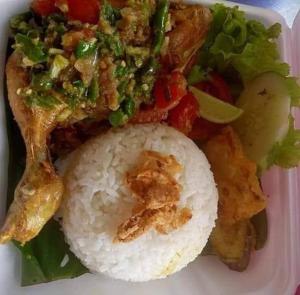 a plate of food with rice and meat and vegetables at Lucky Bamboo'Bungalows and Orangutan Jungle Trekking Tours in Bukit Lawang