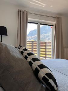 a bedroom with a bed with a large window at Ferienwohnung Traunkirchen mit Seeblick in Traunkirchen