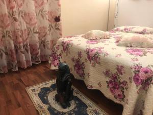 a bedroom with a bed and a statue on a rug at Casa Vicolo del Poeta Acireale in Acireale