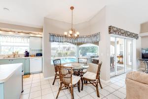 a kitchen and dining room with a table and chairs at Life at the Canal in Cape Coral