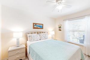 a bedroom with a bed and a ceiling fan at Life at the Canal in Cape Coral +25 photos