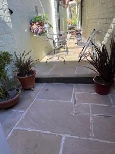 a patio with a bench and some potted plants at St. John’s hill - with parking in Shrewsbury