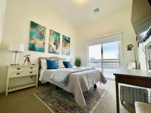 a bedroom with a bed and a desk and a window at A Perfect Getaway in the Heart of the Action in Las Vegas