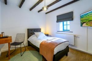 A bed or beds in a room at Landgoed Overste Hof