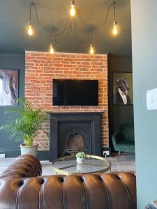 a living room with a couch and a fireplace at Salt Life One Bedroom Apartment in Brighton & Hove