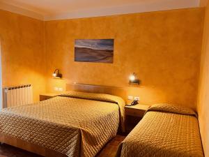 Ένα ή περισσότερα κρεβάτια σε δωμάτιο στο Albergo Di Murlo
