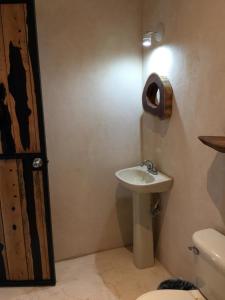 a small bathroom with a sink and a toilet at Aldea Jaguar in Francisco Uh May