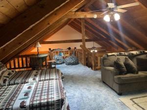 um quarto no sótão com uma cama e um sofá em Bearadise Cabin em Terra Alta