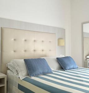 a bedroom with a large bed with two pillows at Albergo Degli Amici in Monterosso al Mare