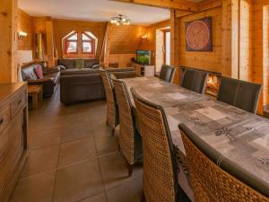 a dining room with a long table and chairs at Chalet LEPERVIERE in Vaujany