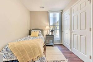a bedroom with a bed and a window at Newly Renovated, Quaint, Modern 2-Bedroom Loft in Front Royal
