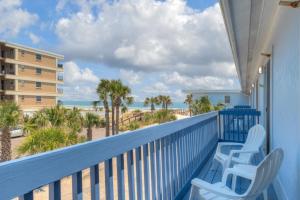 a balcony with chairs and a view of the beach at Sandy Feet Retreat 4 Oceanview Balconies Pets Ok in Jacksonville Beach