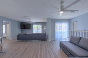 a living room with a couch and a table at Sandy Feet Retreat 4 Oceanview Balconies Pets Ok in Jacksonville Beach