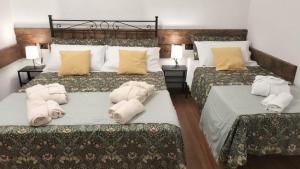 a bedroom with two beds with towels on them at Affittacamere Armanino in Genoa