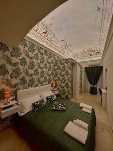 a bedroom with a green bed in a room with a ceiling at M.Mansion in San Giovanni Rotondo