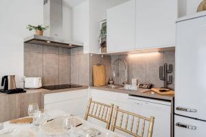 a kitchen with a table and two chairs and a counter at Le Bohème - Charming apartment in the city centre in Annecy