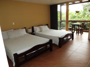 Postel nebo postele na pokoji v ubytování Finca Hotel La Quinta Porra