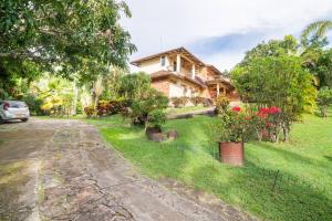 a house on the side of a road with a yard at ANAPOIMA Villa Capri in Anapoima