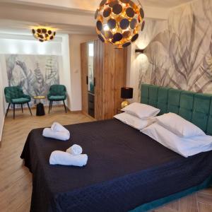 a bedroom with a large bed with towels on it at Apartment Fay in Mali Lošinj