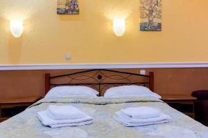 Postel nebo postele na pokoji v ubytování Tiso Apart Hotel