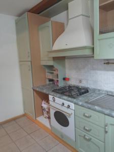 a kitchen with a stove and a white stove top oven at Casa Vacanze da Lino in Nus