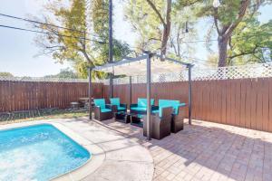 a patio with a table and chairs next to a swimming pool at Good Vibes 4 Bedroom with Private Pool, Close to Houston Loop in Houston