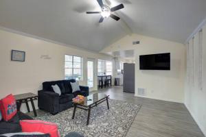 a living room with a couch and a ceiling fan at Good Vibes 4 Bedroom with Private Pool, Close to Houston Loop in Houston