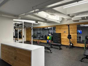 a gym with a white counter and chairs in a room at Mint House Dallas Downtown By Kasa in Dallas