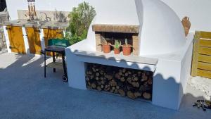 a outdoor grill with plants in pots on it at CASA DI'ELEN in Faliraki