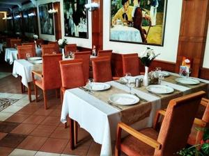a dining room with a table and chairs with plates at Hotel Barbakan in Trnava