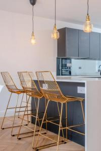 a kitchen with rattan chairs and a counter top at Central 3BD Flat with Balcony in Paddington in London