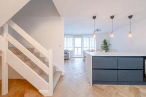 een keuken en een woonkamer met een trap in een huis bij Central 3BD Flat with Balcony in Paddington in Londen