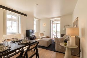 a living room with a table and a couch at Villa Sofia Cascais in Cascais