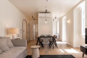 a living room with a couch and a table at Villa Sofia Cascais in Cascais