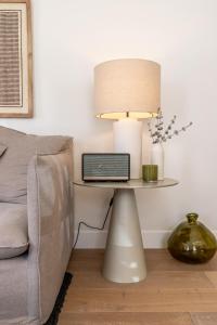 a lamp on a table next to a couch at Villa Sofia Cascais in Cascais