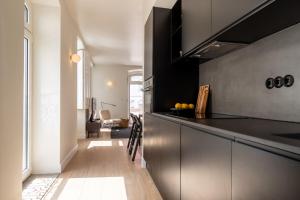 a kitchen with black cabinets and a counter top at Villa Sofia Cascais in Cascais