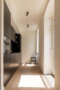 a kitchen with a stainless steel refrigerator and a table at Villa Sofia Cascais in Cascais