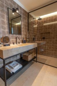 a bathroom with a sink and a mirror and a shower at Villa Sofia Cascais in Cascais