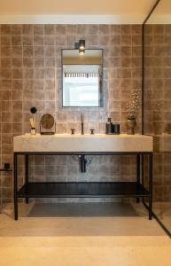 a bathroom with a sink and a mirror at Villa Sofia Cascais in Cascais