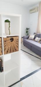 a living room with a couch and a table at Apartamentos La Libertad Estepona in Estepona