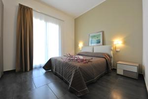 a hotel room with a bed and a window at Case Mistretta in Altavilla Milicia +19 photos