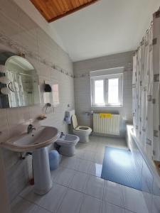 a bathroom with a sink and a toilet and a mirror at Seaview apartment Marta in Crveni Vrh